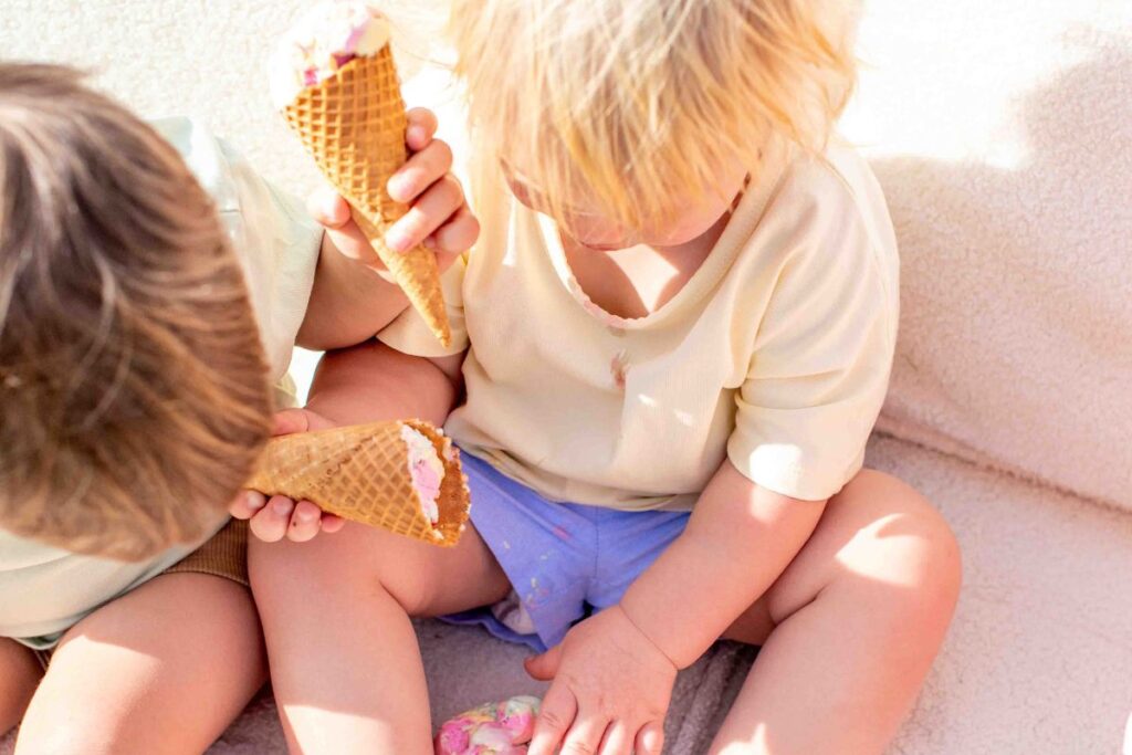 am children enjoying ice cream wearing Cubs Closet apparel.
