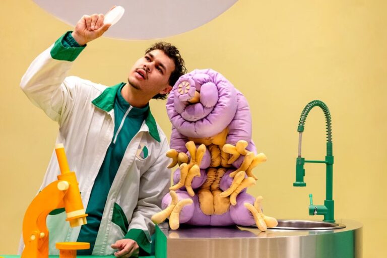 Windmill Theatre production Moss Piglet. character in a lab coat with science laboratory equipment.