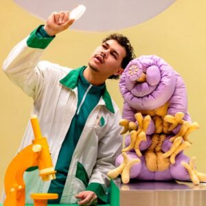 Windmill Theatre production Moss Piglet. character in a lab coat with science laboratory equipment.