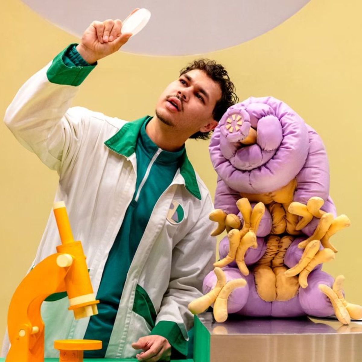 Windmill Theatre production Moss Piglet. character in a lab coat with science laboratory equipment.