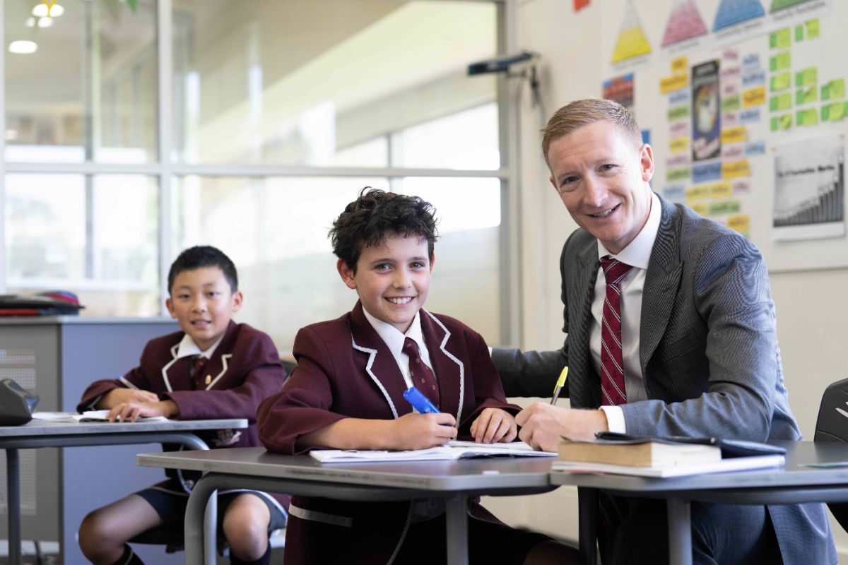 Year 5 Prince Alfred College students in class with a teacher.