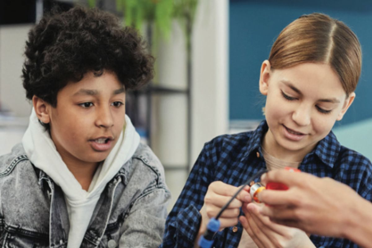 Students learning practical technical skills in a classroom.