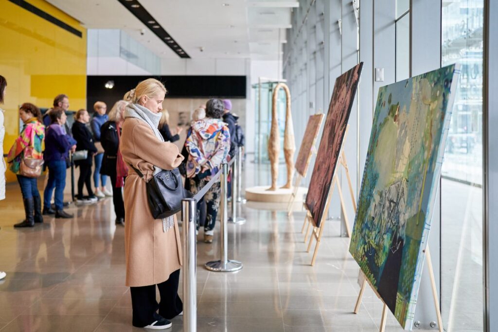 Calling All SA Artists: Registrations are now open for the 2026 SALA Festival. A woman looks at a paining in a gallery.