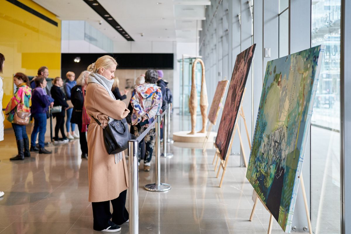 Calling All SA Artists: Registrations are now open for the 2026 SALA Festival. A woman looks at a paining in a gallery.