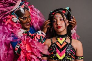 Girl and woman in colourful costume for Tune In! The Frequency Within Fringe show.