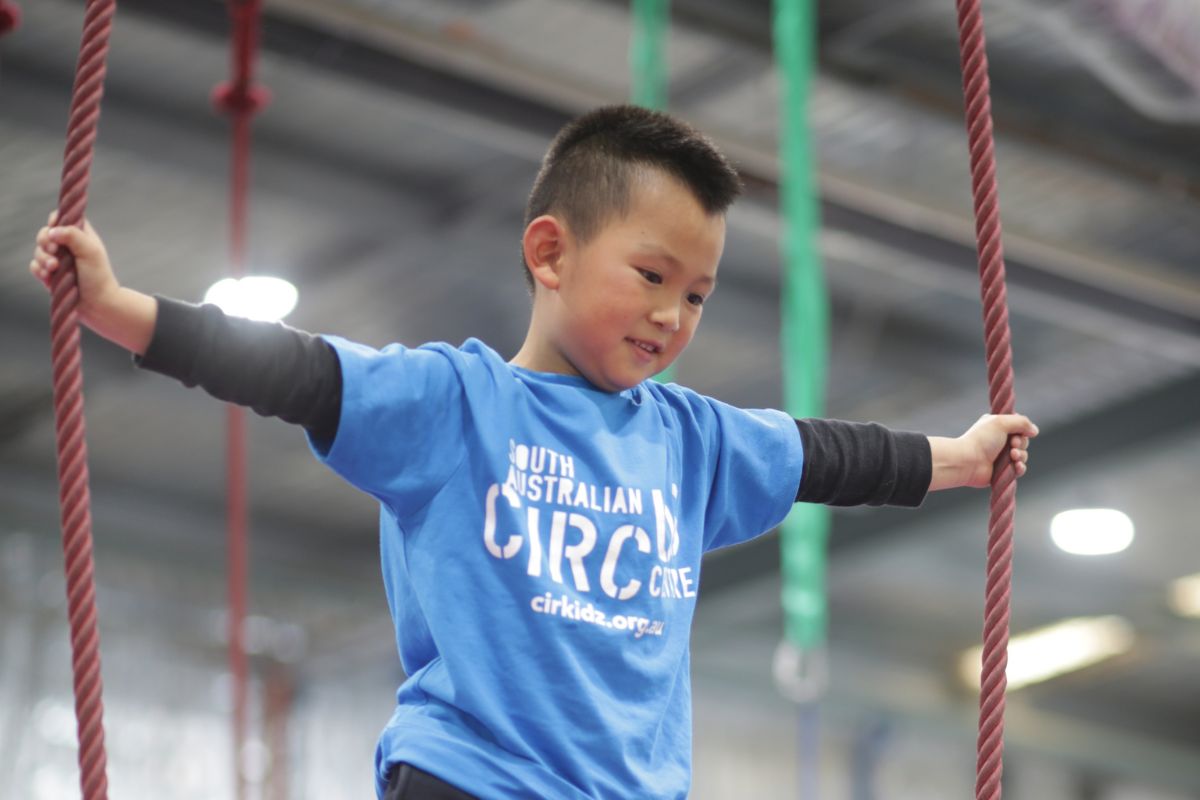 Cirkidz boy in blue t-shirt.