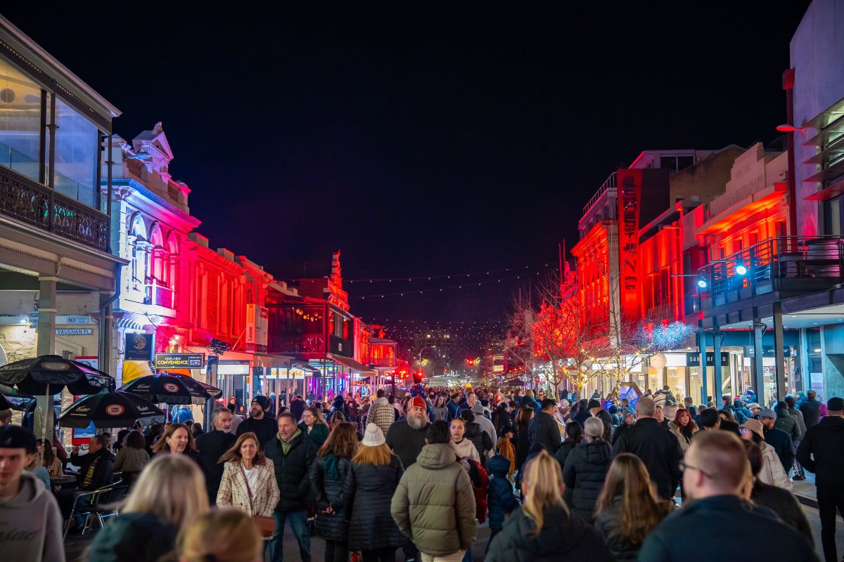 Crowds exploring illuminated Rundle Street during Illuminate Adelaide City Lights in Adelaide at night