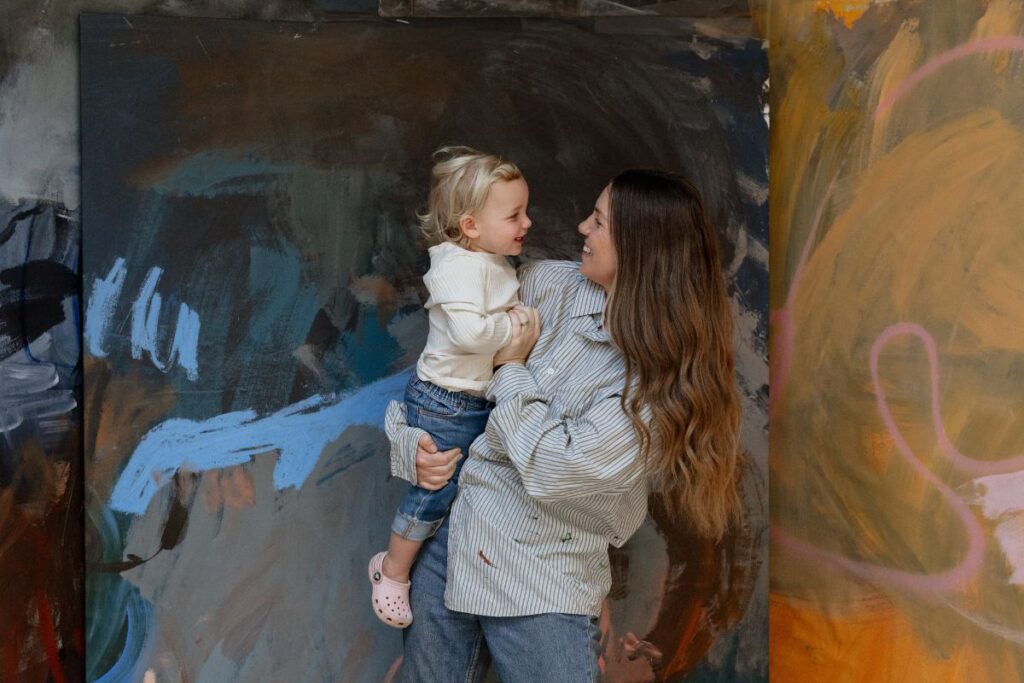 Artist Madeleine Collopy and child in her art studio.