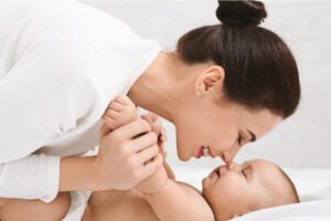 Mother holding baby nose to nose in a special moment.