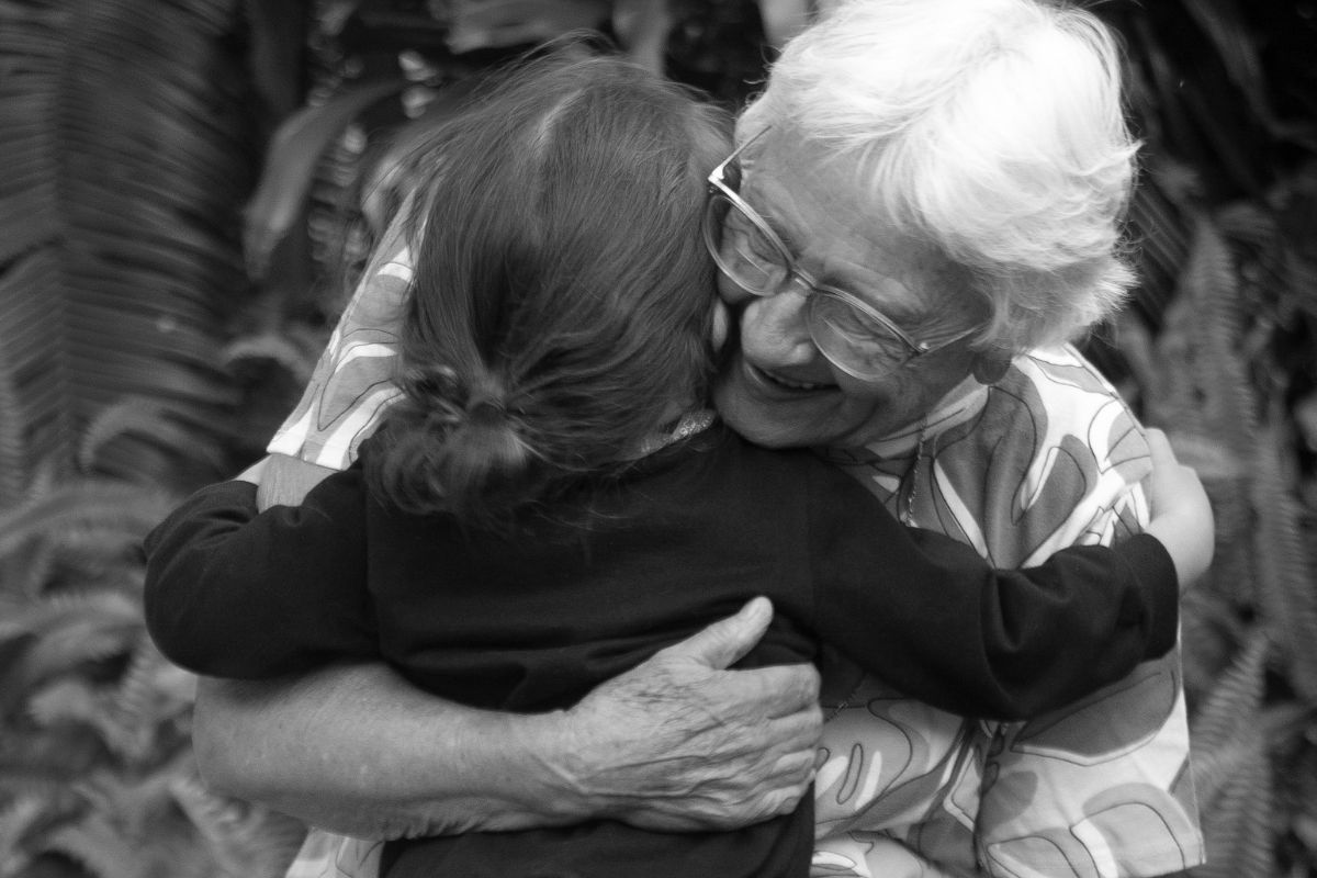 A grandmother and grandchild in a warm embrace.