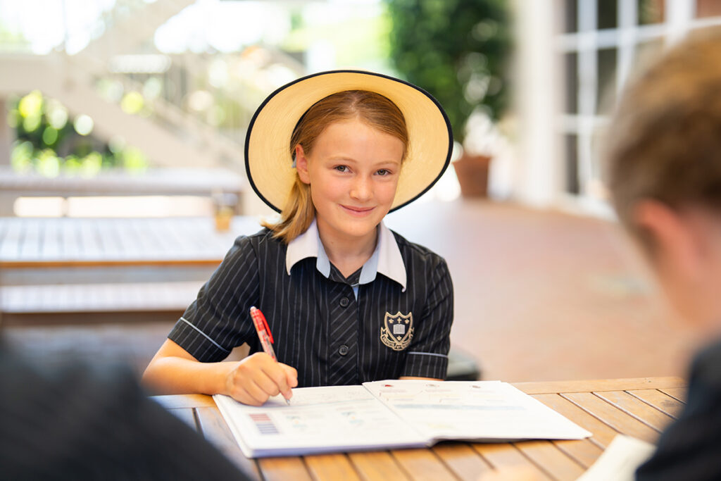Walford School, Adelaide. Student in school uniform and school hat.