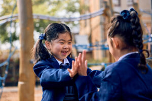 St Mary's School girls in uniform playing outside.