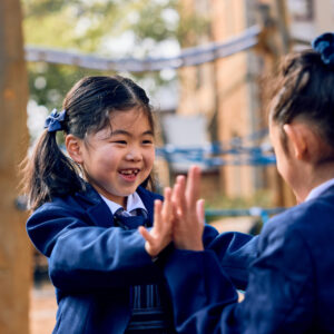 St Mary's School girls in uniform playing outside.