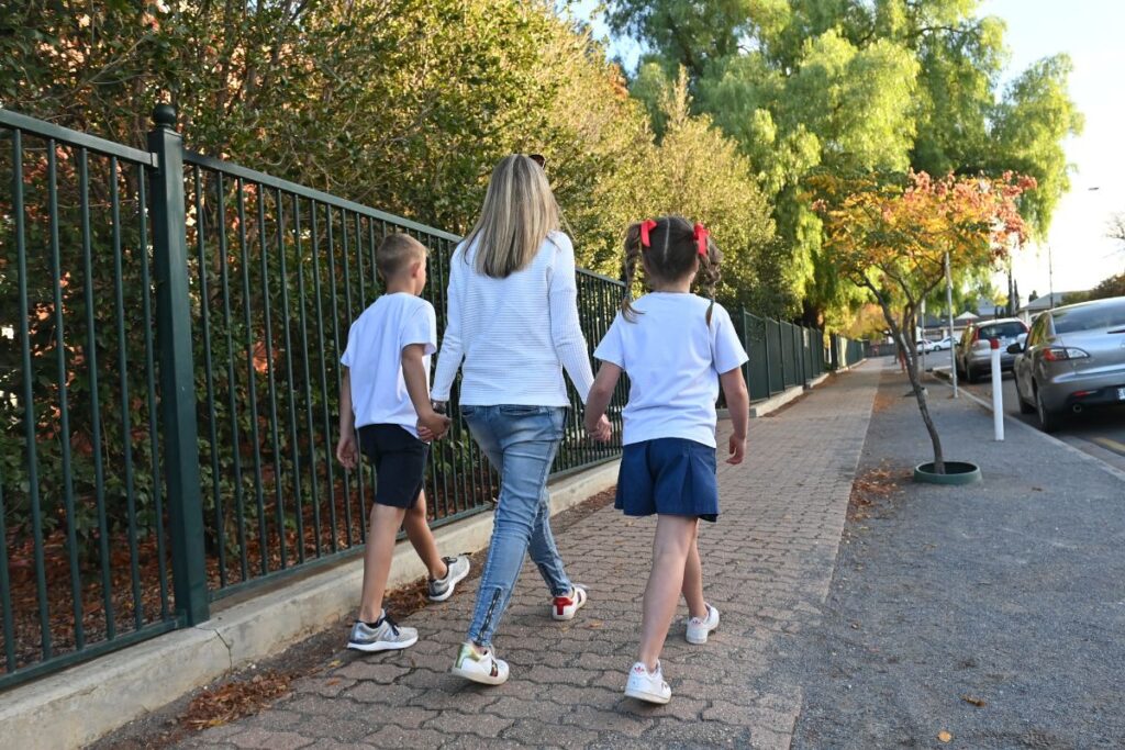 Children walking to school with parent.