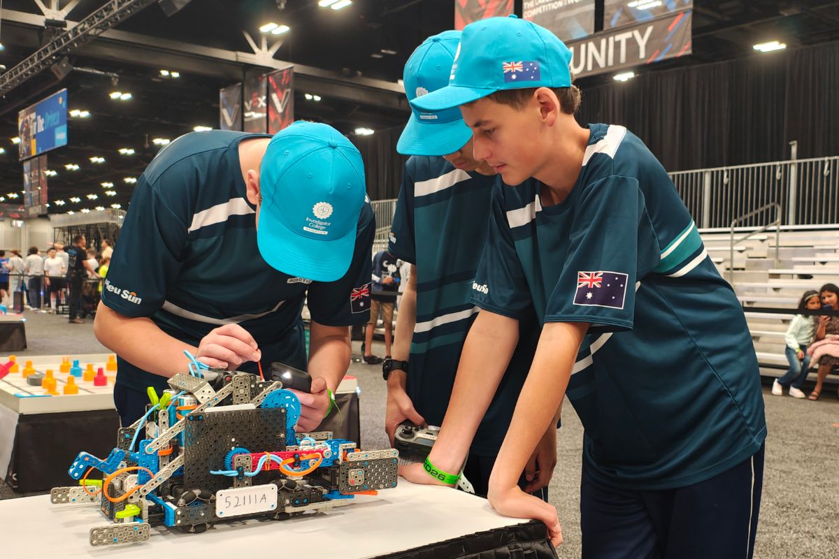 Investigator College students working on a robotics project.