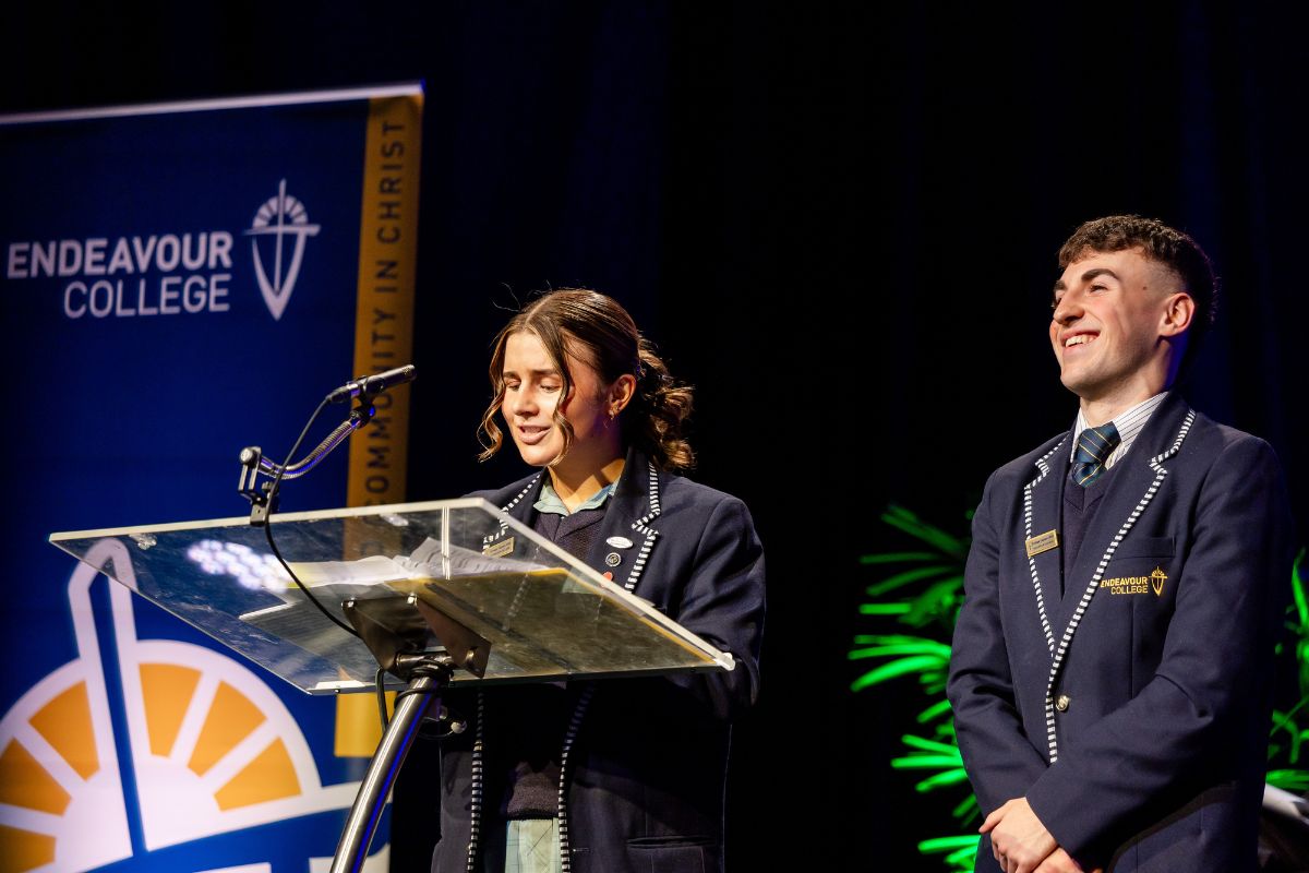 An Endeavour College student stands at a podium.