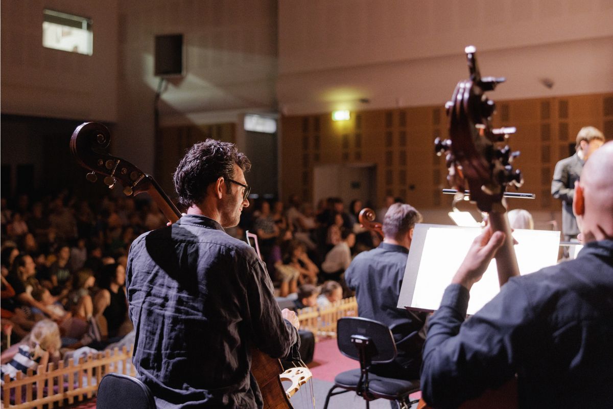 Adelaide Symphony Orchestra musicians face a packed audience of children and families during a live performance