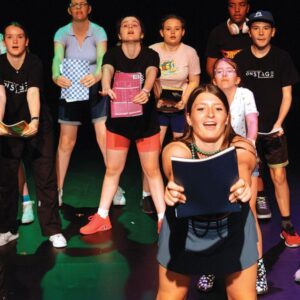 students performing on stage.