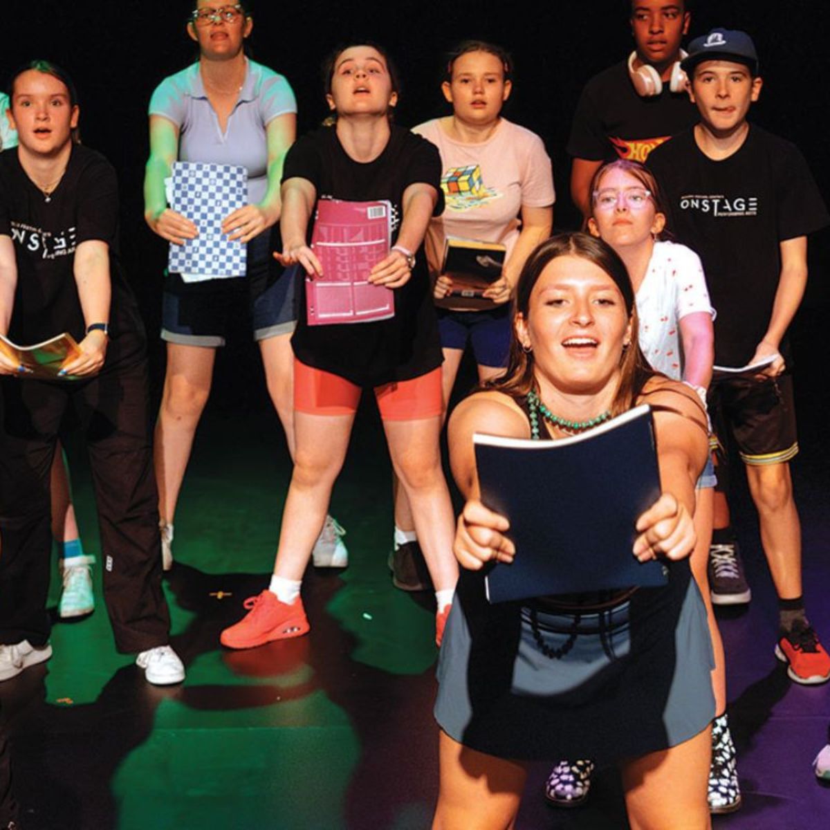 students performing on stage.