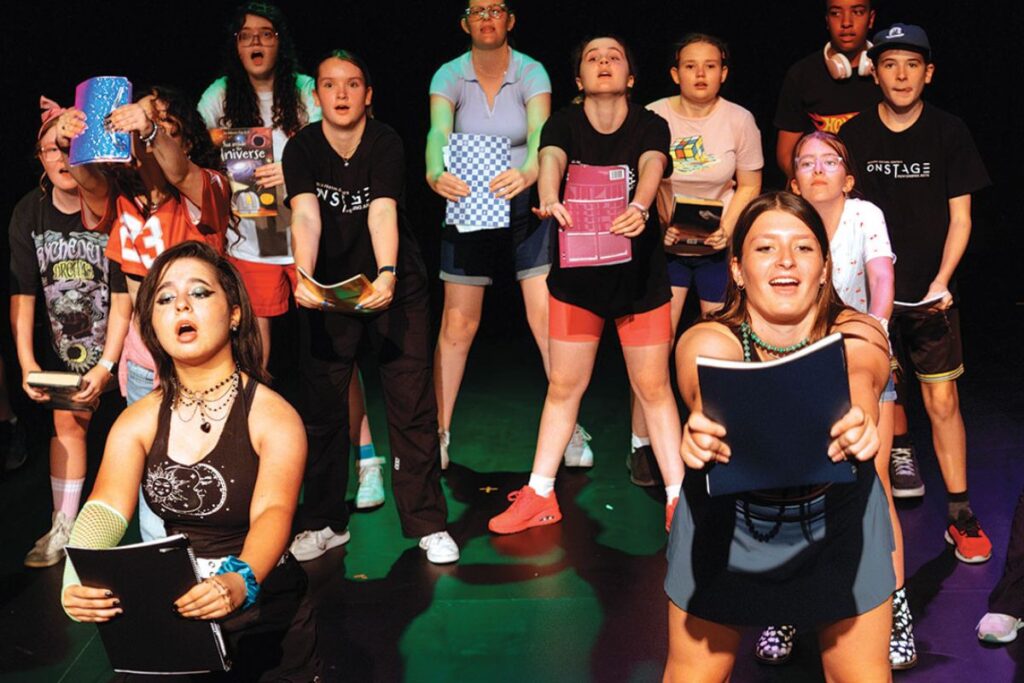 students performing on stage.