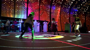 Players competing on an illuminated interactive floor at Augmented Games, Adelaide Showground