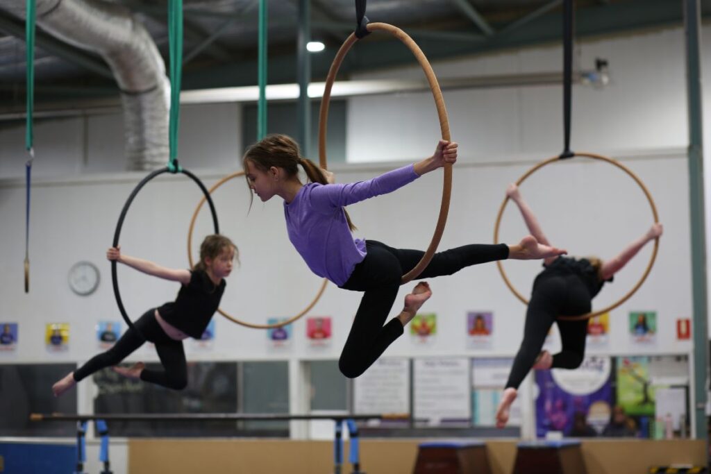 Kids performing aerial hoop acrobatics at Cirkidz Wicked Winter School Holiday Program