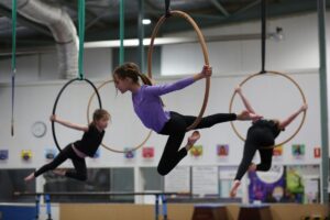 Children performing aerial hoop routines at Cirkidz, SA Circus Centre Bowden
