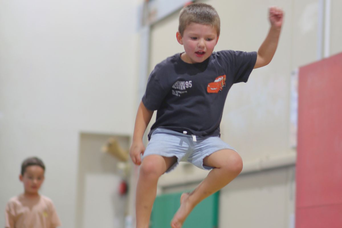 Boy jumping with energy during a Cirkidz school holiday program at SA Circus Centre Bowden