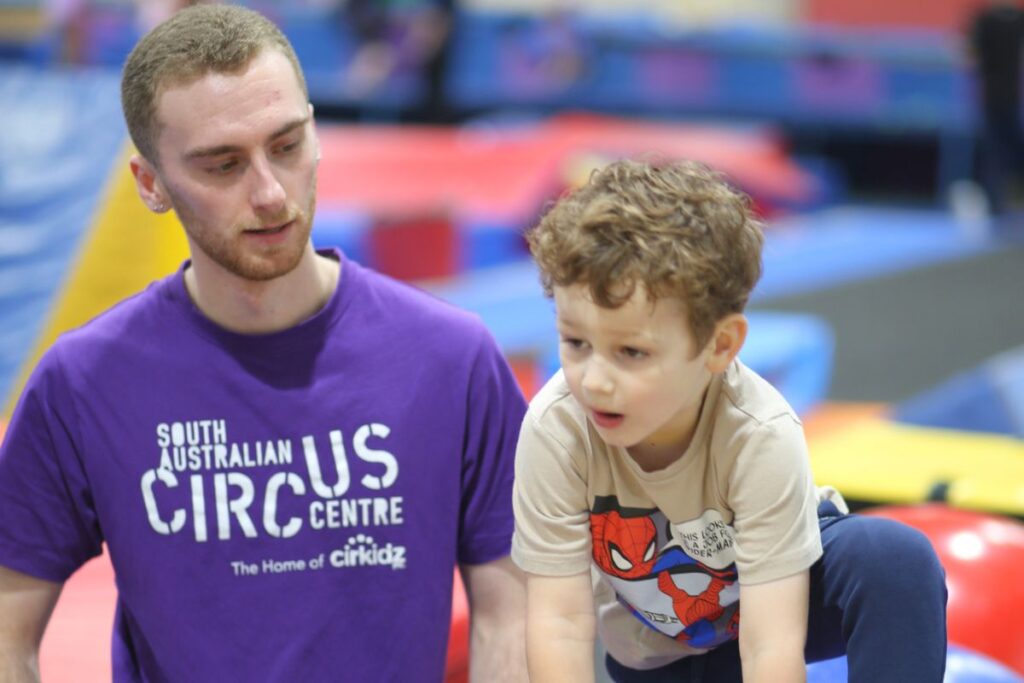 SA Circus Centre instructor guiding a young child during a Cirkidz session at Bowden.