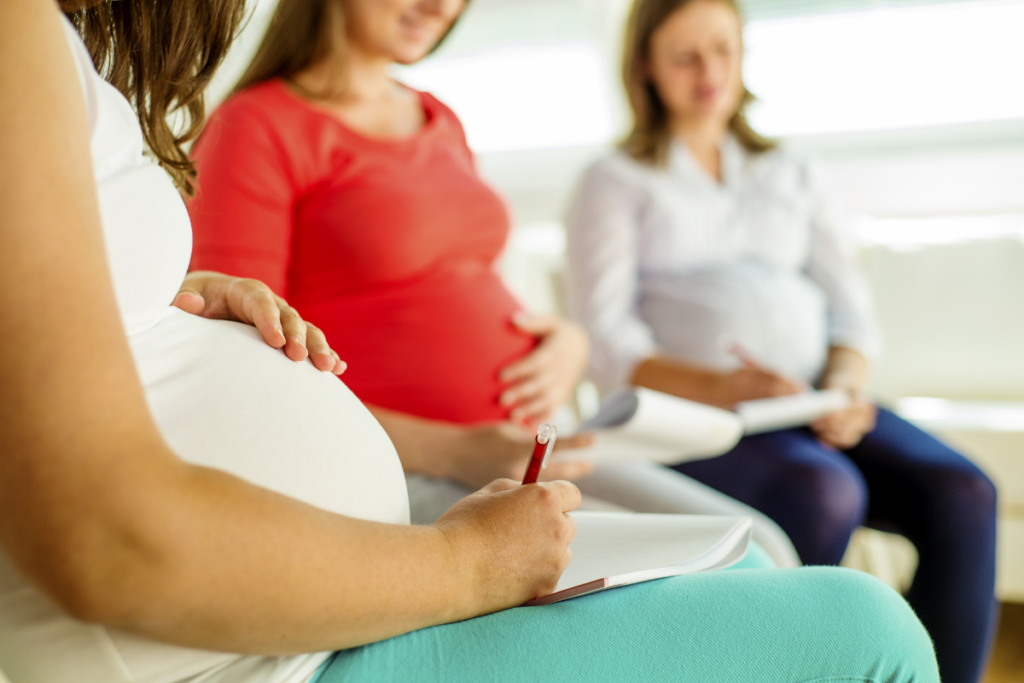 A group of pregnant women sitting in a circle for a maternity class.