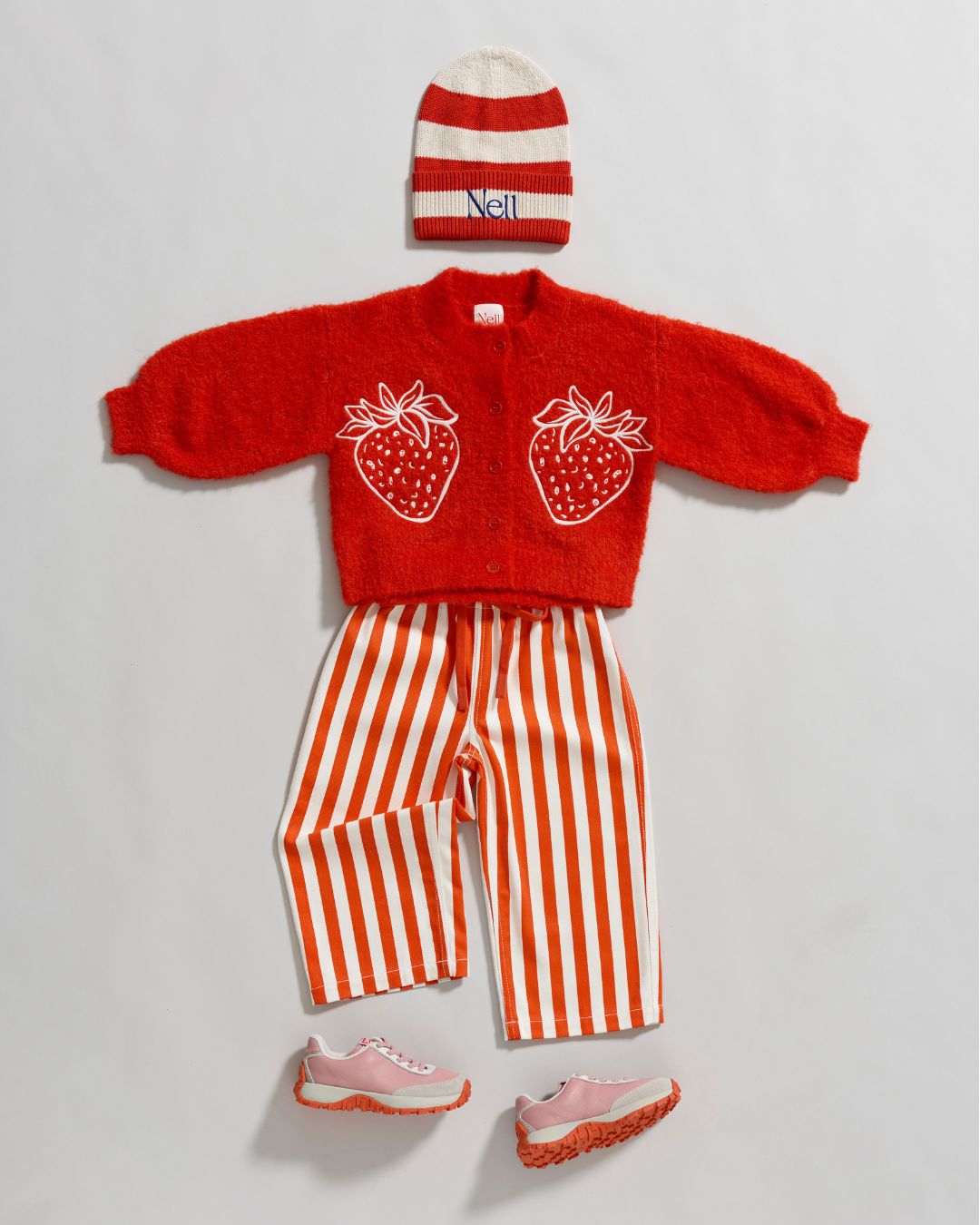 Nell children's clothing, red striped hat and top with red cardigan with strawberries on the front. 