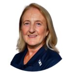 Edwina Reid, founder of NeuroPhysiotherapy Services, smiling in a navy polo shirt