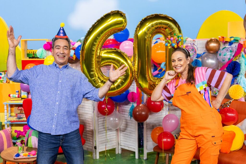 Play School presenters celebrating with gold number 60 balloons for the show's 60th anniversary