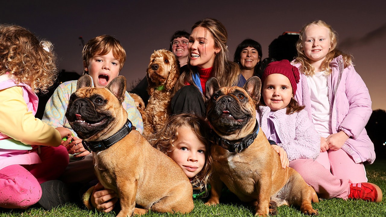 Children and adults gathered around dogs at a family event, Adelaide Showground
