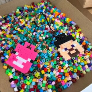 Colourful melty bead designs, including a Minecraft-style creeper face, made from Perler beads