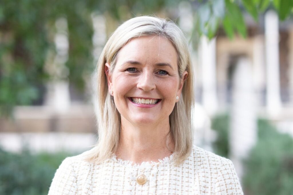 Seymour College Principal Vanessa Browning standing outside in the schoolyard smiling.