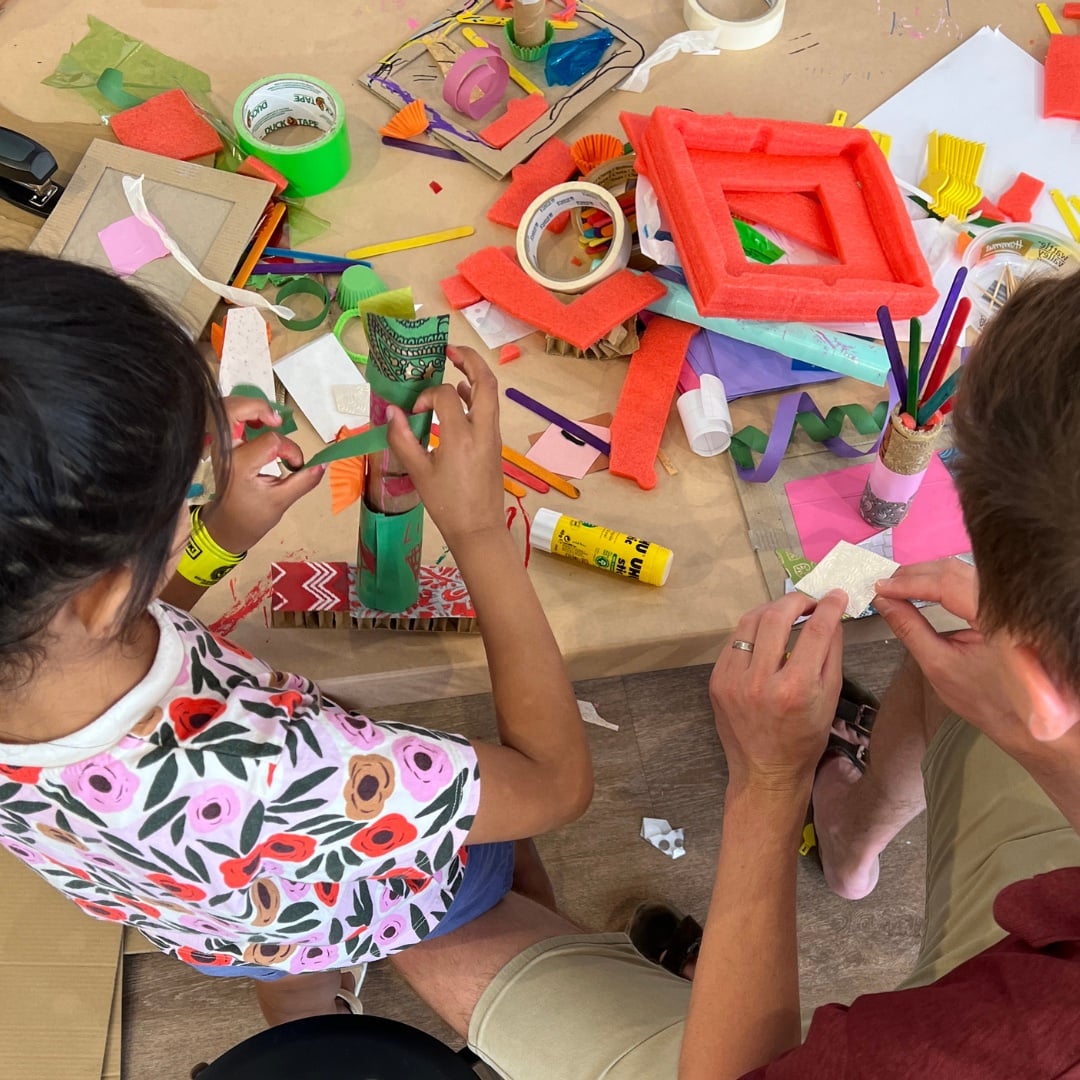Children creating art from recycled materials at Re:PLAY workshops