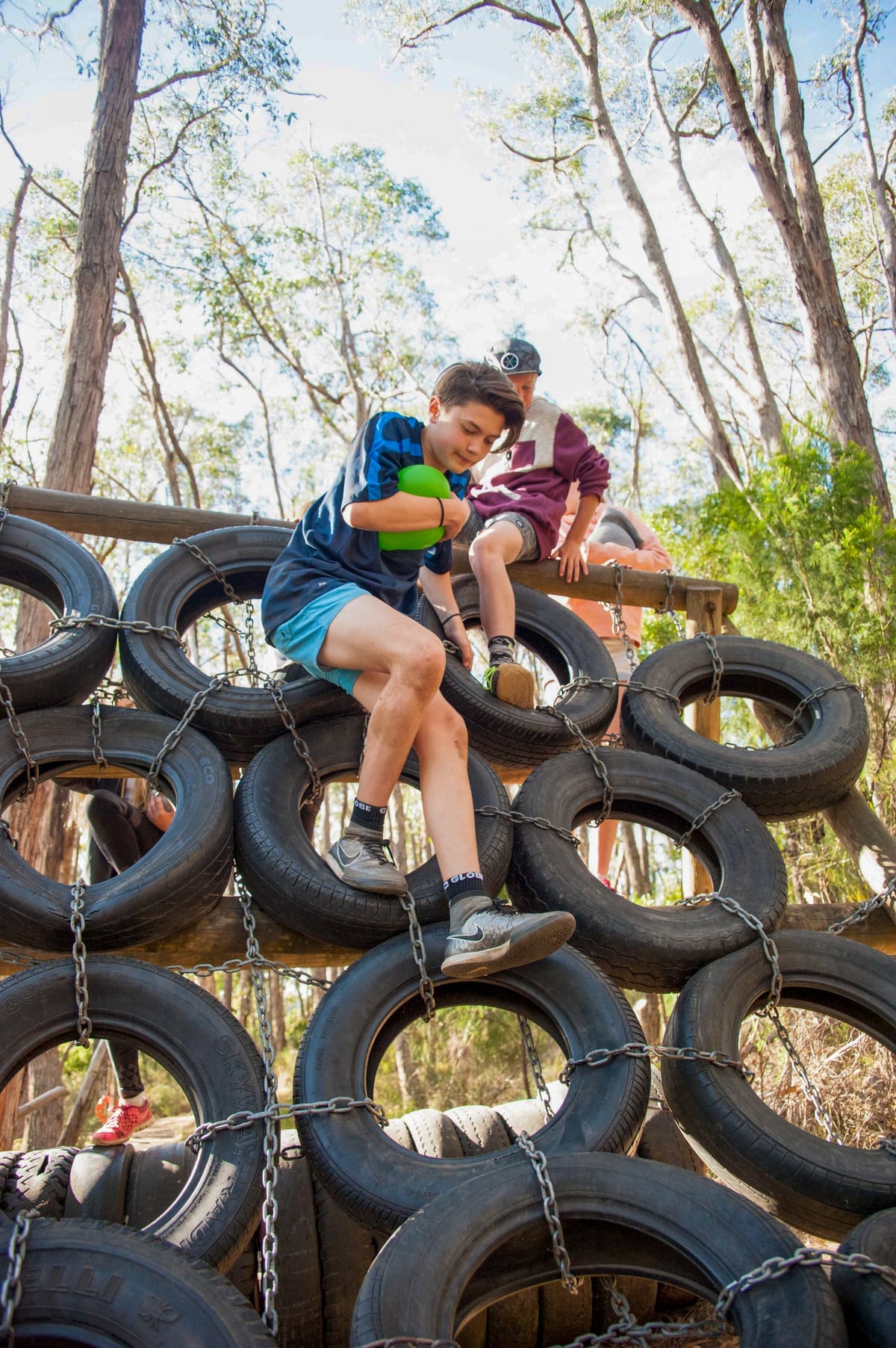 Kids tackling outdoor climbing challenges at Wilderness Escape