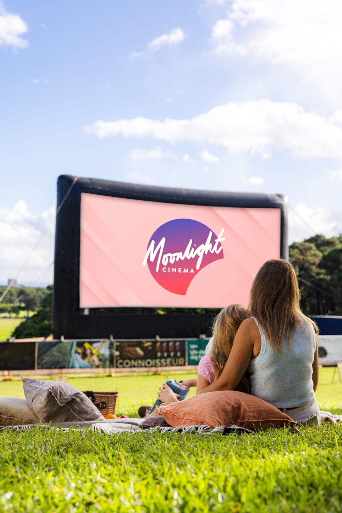 Moonlight Cinema - Lifestyle - Two friends on rug by the screen - Portrait